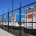 Image showing a row of waste management trucks behind a Fencerite chainlink security fence