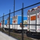 Image showing a row of waste management trucks behind a Fencerite chainlink security fence