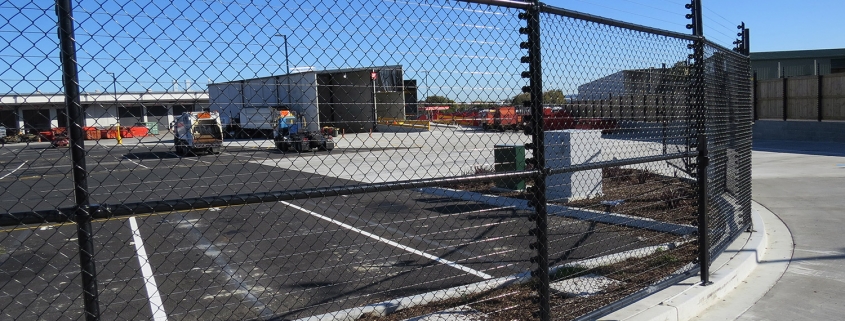 Image showing a Fencerite chainlink fence bordering an industrial carpark with building in the background