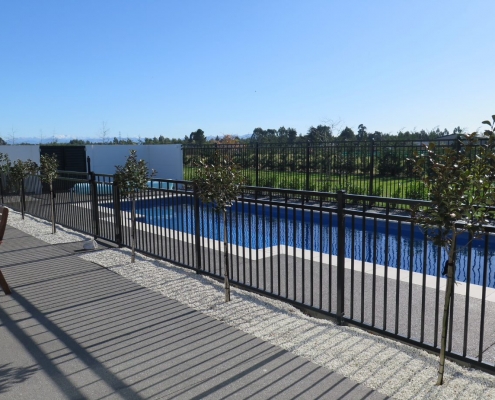 Image showing a beautiful residential swimming pool surrounded by pool fencing