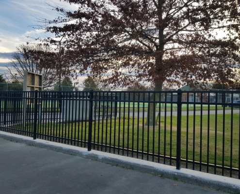 Image showing black aluminium school fencing, bordering the entrace to a school