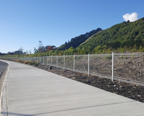 Image showing a long stretch of footpath with bordering welded wire security fencing, installed by Fencerite