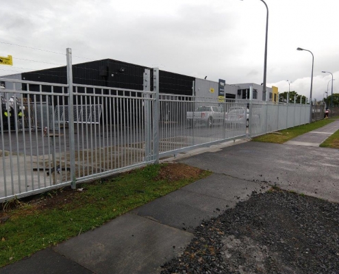 Image showing an entrance to a commercial premises, with sliding gate and security fencing, installed by Fencerite