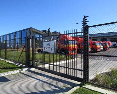 Image showing an entrance to Waste Management, including a sliding security gate, installed by Fencerite