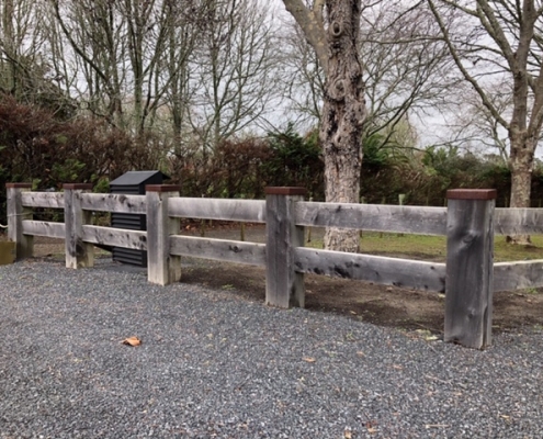 Image showing a wooden fence, bordering a rural driveway, installed by Fencerite