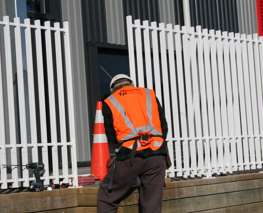 image of a man installing a security fence