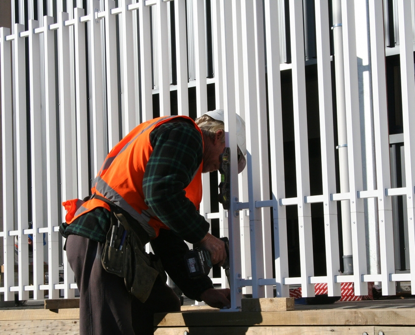 image of a man installing a fence